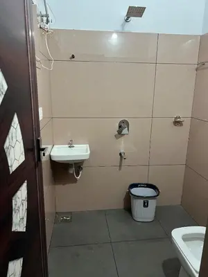 a small bathroom with a sink and a toilet at Mynakam - A peaceful escape in Vythiri
