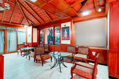 a room with tables and chairs and a projection screen at Collection O Puthali Park Near Mysuru Railway Station in Mysore