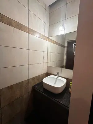 a bathroom with a sink and a mirror at DB GUEST HOUSE ARIMPUR - Unmarried couples and Stag groups not allowed in Trichūr