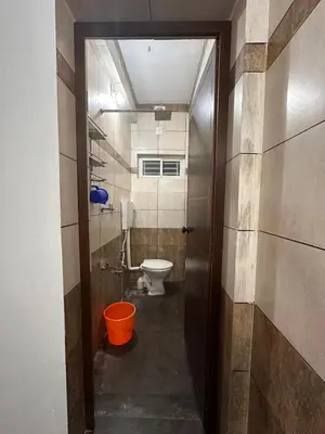 a bathroom with a toilet and a bucket in it at DB GUEST HOUSE ARIMPUR - Unmarried couples and Stag groups not allowed in Trichūr