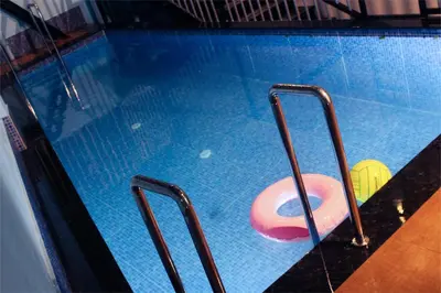 a swimming pool with a pink object in it at VGK Residency in Wayanad