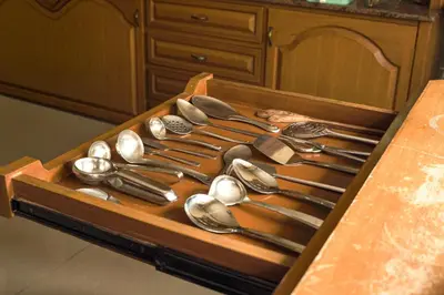 a wooden tray filled with utensils on a table at Aarroh villa in Coonoor