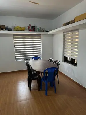 a dining room with a wooden table and chairs at Oryx Villai in Vythiri