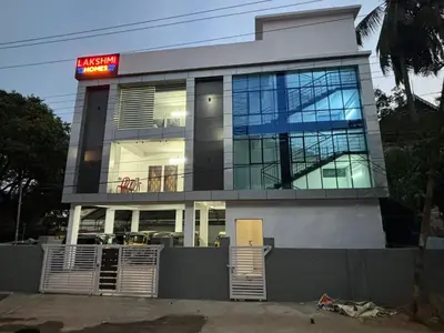 a building with a sign on top of it at Lakshmi Home in Trichūr