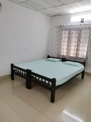 a large bed in a room with at Thiruvambady Heritage Homestay in Trichūr
