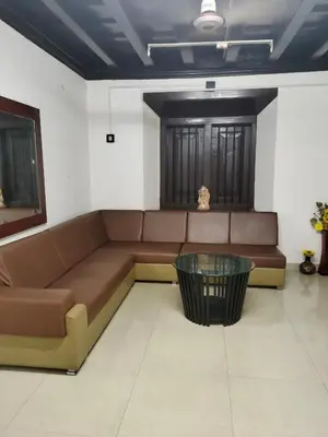 a living room with a couch and a glass table at Thiruvambady Heritage Homestay in Trichūr