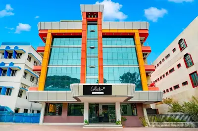 a large building with a sign in front of it at Collection O City Bus Station Mysuru in Mysore