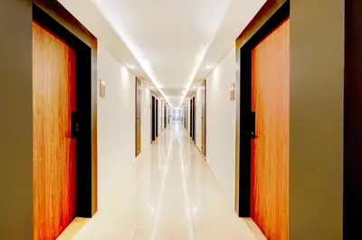 a corridor of a hospital with doors and a long hallway at Collection O City Bus Station Mysuru in Mysore