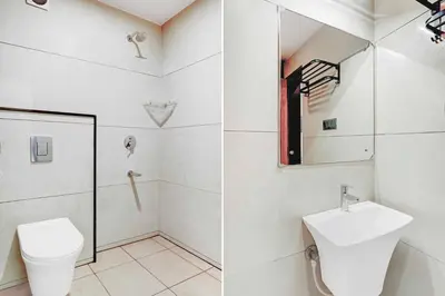 a bathroom with a toilet and a sink at Collection O City Bus Station Mysuru in Mysore
