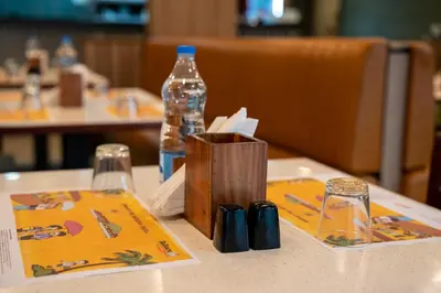 a bottle of water sitting on top of a table at Royal Plaza Glitz Inn in Kozhikode
