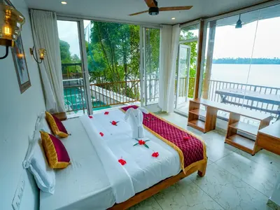a bedroom with a bed with red roses on it at Lake view Resort cherai in Cherai Beach
