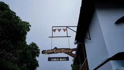 a sign for a green restaurant on the side of a building at Lake view Resort cherai in Cherai Beach