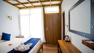 a bedroom with a bed with two toy rabbits on it at Lake view Resort cherai in Cherai Beach