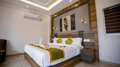 a bedroom with a large white bed in a room at Lake view Resort cherai in Cherai Beach