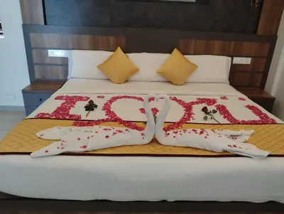 a bed with two pillows on top of it at Lake view Resort cherai in Cherai Beach