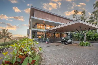 a house with a car parked in front of it at EVORA Resort and SPA in Ambalavayal