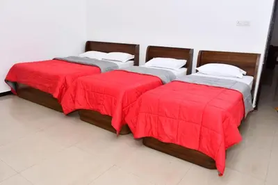 two beds with red covers sitting in a room at Classic Homestay Hills Ooty in Ooty