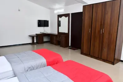 a bedroom with a bed with a red blanket at Classic Homestay Hills Ooty in Ooty