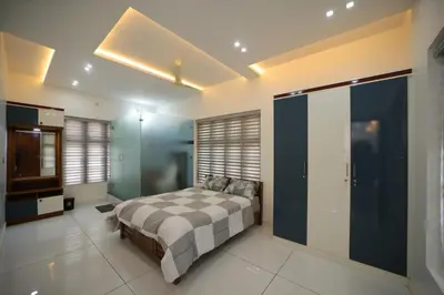 a bedroom with a large bed in a room at Village Pavilion in Tellicherry