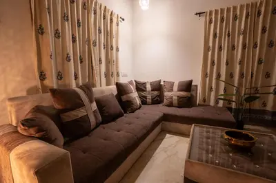 a living room with a couch and a table at Meenakshi residency in Alāndurai