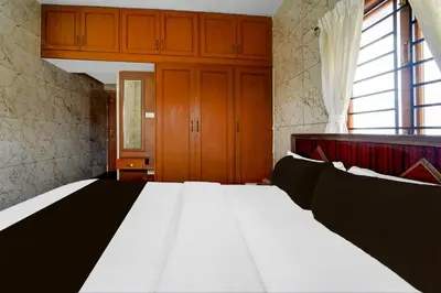 a bedroom with a large white bed in a room at Super Collection O Omni Bus Terminal Gandhipuram Formerly Apple Grand in Coimbatore