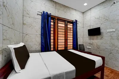 a bedroom with a bed and a window at Super Collection O Omni Bus Terminal Gandhipuram Formerly Apple Grand in Coimbatore