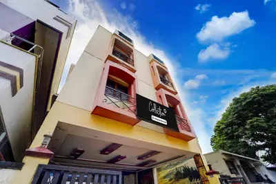 a building with a sign on the side of it at Super Collection O Omni Bus Terminal Gandhipuram Formerly Apple Grand in Coimbatore
