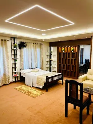 a large bedroom with a bed and a couch at Joevilla-1BHK Near Kottiyoor in Kelakam