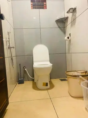 a bathroom with a white toilet and a shower at Joevilla-1BHK Near Kottiyoor in Kelakam