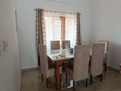 a dining room with a table and chairs at La-Casona in Kottayam