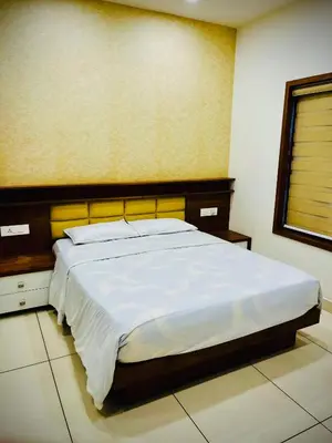 a bedroom with a large bed in a room at Joevilla - 3BHK Near Kottiyoor in Kelakam