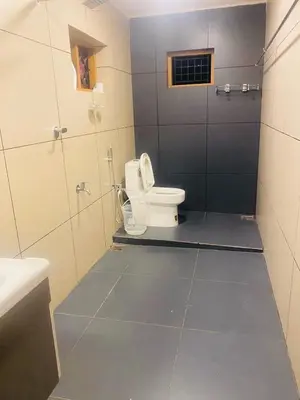a bathroom with a toilet and a sink at Joevilla - 3BHK Near Kottiyoor in Kelakam