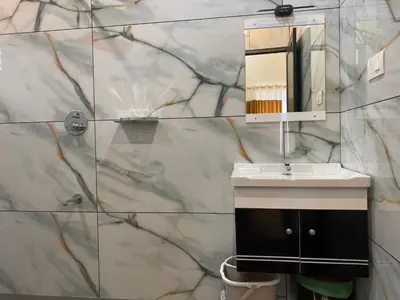 a bathroom with a sink and a mirror at Wayanad Mona Villa in Wayanad