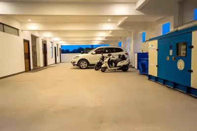 a car and a motorcycle parked in a garage at Cross Roads Inn in Coimbatore