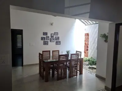 a dining room with a table and chairs at Eden Villa in Meenangadi