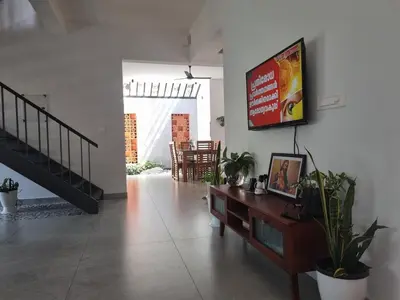 a living room with a flat screen tv on the wall at Eden Villa in Meenangadi