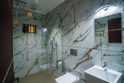 a bathroom with a sink and a toilet at DQ Premium Apartments in Ernakulam