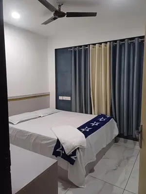 a bedroom with a bed with a ceiling fan at Dream Stay Mukkam in Mukkam