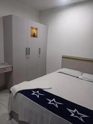 a bedroom with a bed with stars on it at Dream Stay Mukkam in Mukkam