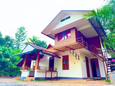 a house with a balcony on the side of it at Wayanad Coffee Vintage in Wayanad
