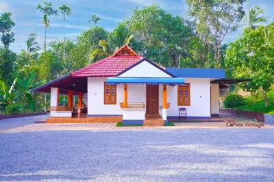 a small house with a red roof at Wayanad Coffee Vintage in Wayanad
