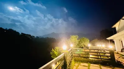 a view from a house at night with lights at White Fort Holiday Home in Vythiri