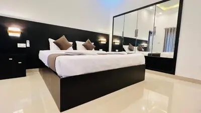 a bedroom with a large bed with a large mirror at White Fort Holiday Home in Vythiri