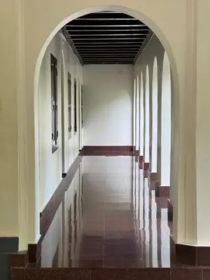 an empty hallway with an archway in a building at Kerala Heritage Private Pool Villa - Tharavad in Māla
