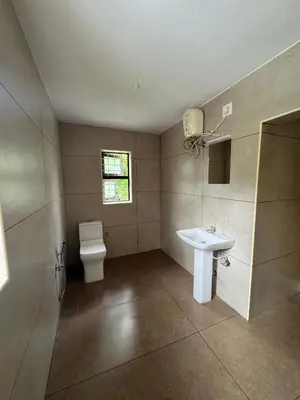 a bathroom with a toilet and a sink at Kerala Heritage Private Pool Villa - Tharavad in Māla