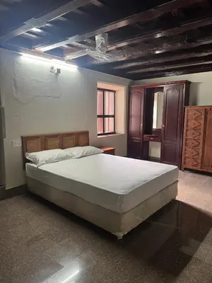 a bedroom with a large bed in a room at Kerala Heritage Private Pool Villa - Tharavad in Māla