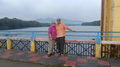 a man and a woman standing on a bridge near the water at Jewel Homes Thattekad For birding and families - An ISO9001 ISO14001 ISO22000 Certified in Thattakād