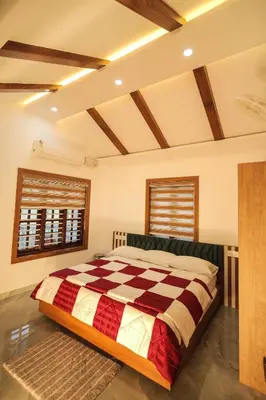a bedroom with a large bed in a room at Wayanadan Huts Homestay in Sultan Bathery