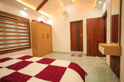 a bedroom with a bed and wooden doors and a sink at Wayanadan Huts Homestay in Sultan Bathery