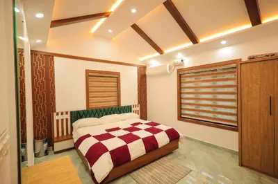a bedroom with a bed with a checkered blanket at Wayanadan Huts Homestay in Sultan Bathery